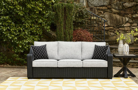 Beachcroft outdoor sofa black frame with light gray cushions, angled side view