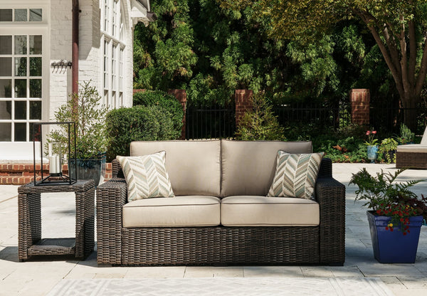 Coastline Bay Brown Outdoor Loveseat front angle with cushions