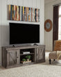 Wynnlow Gray Rustic solid wood TV stand with cabinet, angled front view