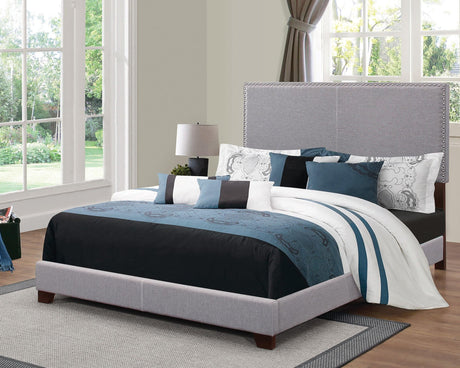 Boyd Queen Upholstered Bed front view showing charcoal upholstery and nailhead trim