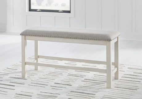 Robbinsdale antique white 49-inch counter height dining bench with light gray upholstered cushion, angled view