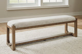 Front angle of Cabalynn 63-inch dining bench with oatmeal upholstery and light brown wood base