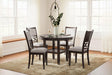 Langwest brown round dining table and 4 beige upholstered chairs front view