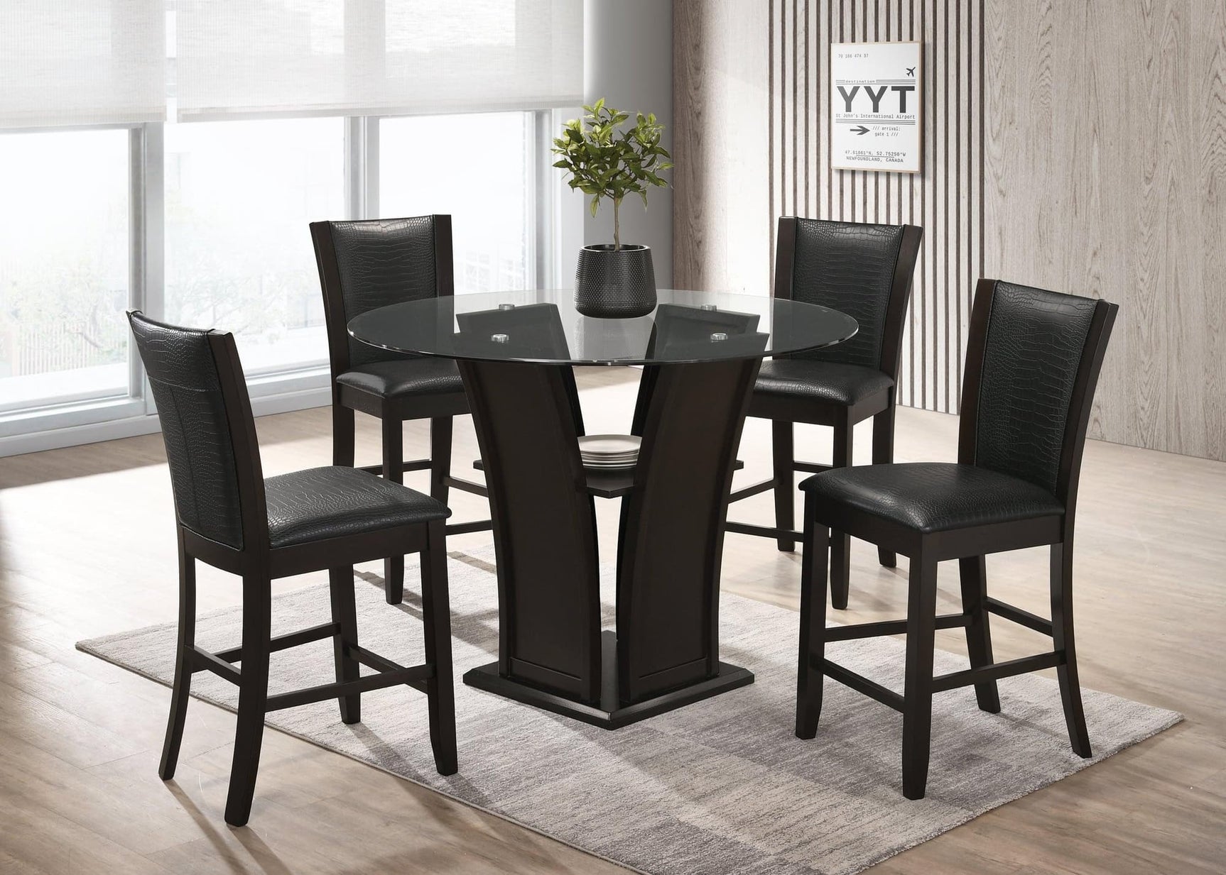 Orlo dining set main view showing round glass top table and four black faux leather chairs