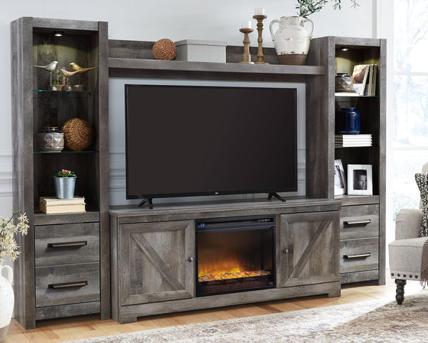 Wynnlow Gray 4-Piece Entertainment Center front view with electric fireplace lit