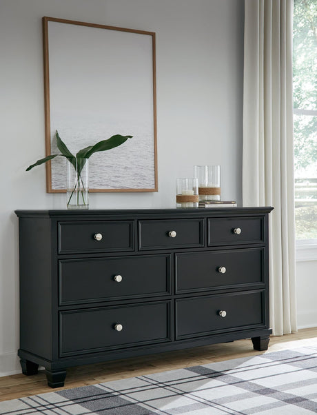 Lanolee Black dresser front view showing seven drawers and tapered feet