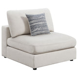 Serene beige upholstered armless chair angled front view