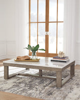 Loyaska Coffee Table angled view showing brown wood-tone base and ivory marble top