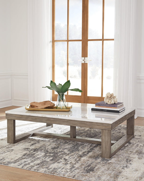 Loyaska Coffee Table angled view showing brown wood-tone base and ivory marble top