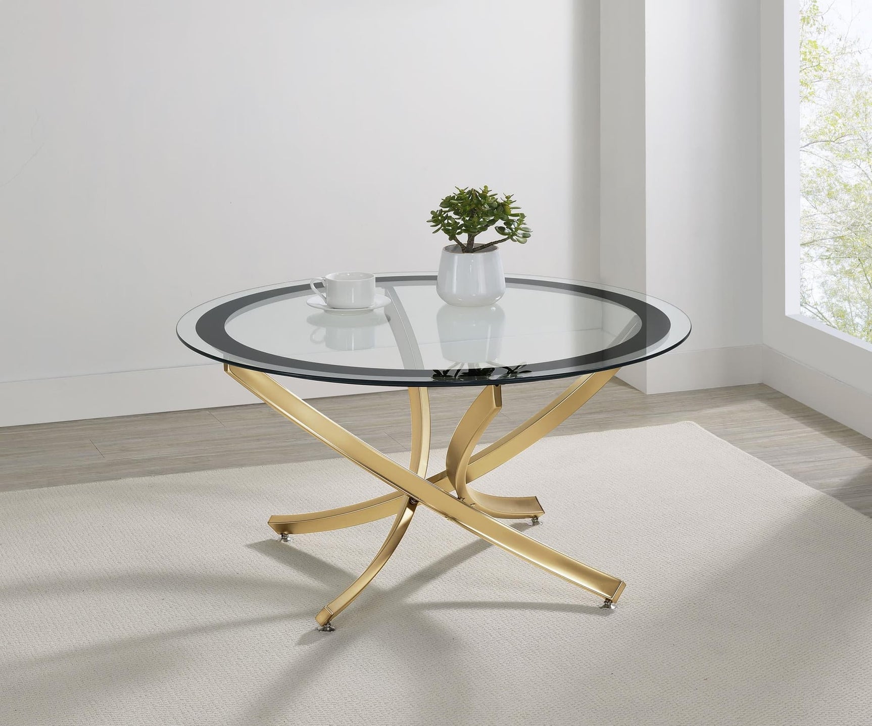Brooke round coffee table with glass top and rose brass metal base, front view