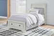 Twin sleigh storage bed in antique white finish showing curved headboard