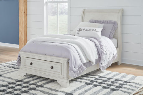 Twin sleigh storage bed in antique white finish showing curved headboard
