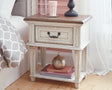 Realyn Chipped White Nightstand angled view showing drawers