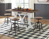 Valebeck white and brown counter height dining table with four swivel barstools