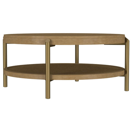 Arini round coffee table with sand wash finish and woven rattan storage shelf, front angle