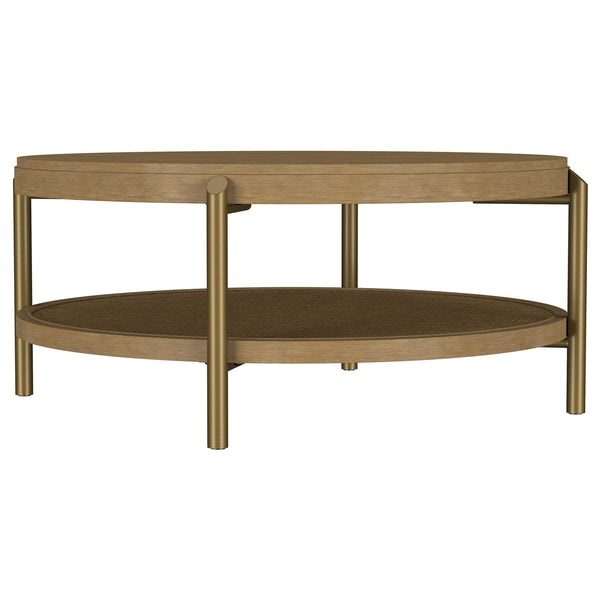 Arini round coffee table with sand wash finish and woven rattan storage shelf, front angle