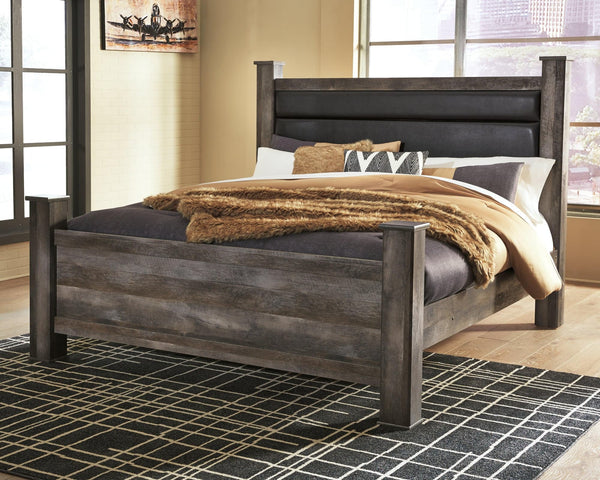 Wynnlow Gray King Poster Bed front view showing upholstered headboard and posts