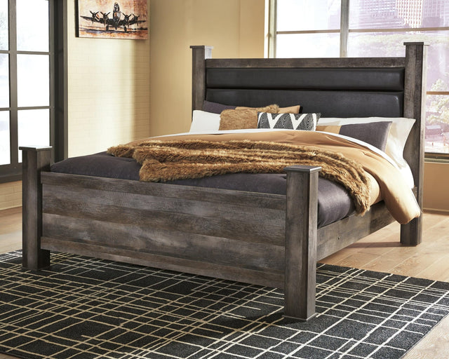 Wynnlow Gray King Poster Bed front view showing upholstered headboard and posts
