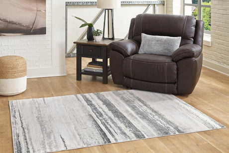 Abanett Multi 5'3" x 7'3" rug in living room setting