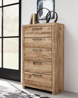 Hyanna Chest of Drawers in tan finish showing front angle with drawers closed