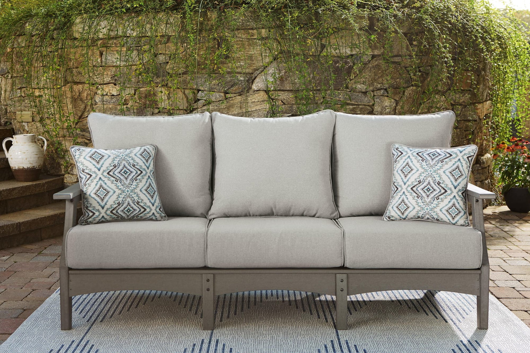 Visola Gray Outdoor Sofa with cushions angled view