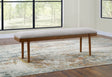 Lyncott 59 inch Upholstered Dining Bench angled view showing gray cushion and brown wood frame