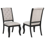 Phelps tan upholstered dining side chair with tufted back and bronze nailhead trim, front view