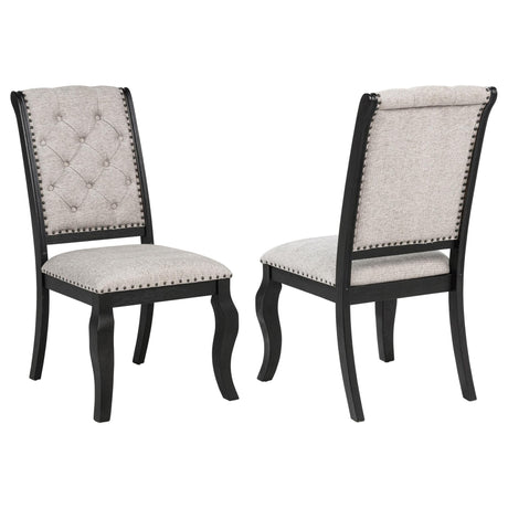 Phelps tan upholstered dining side chair with tufted back and bronze nailhead trim, front view