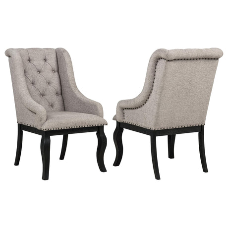 Phelps Upholstered Dining Arm Chair front view with tan fabric and distressed noir frame