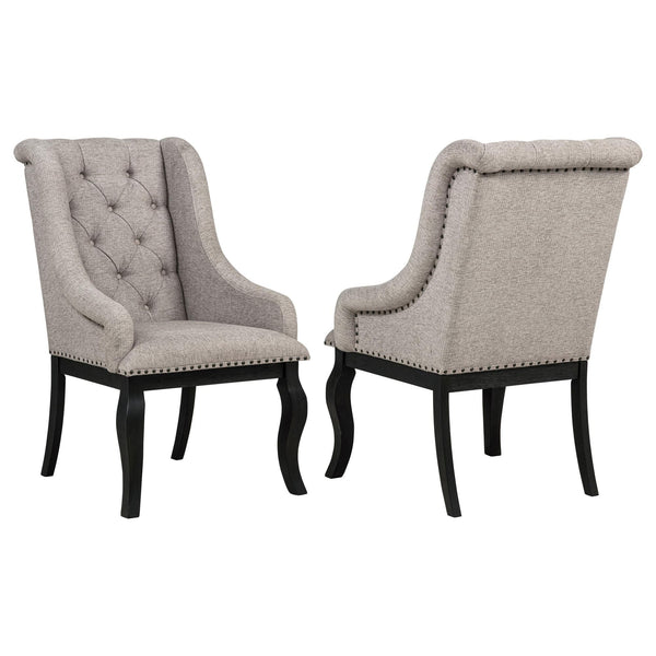 Phelps Upholstered Dining Arm Chair front view with tan fabric and distressed noir frame