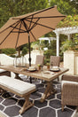 Beachcroft Beige Outdoor Dining Table, front angle showing porcelain top and X-leg farmhouse base