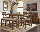 Moriville grayish brown counter height dining table with upholstered bar stools and bench, view from front angle