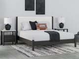 Cadmori King Upholstered Panel Bed frontal view with black finish and white upholstery