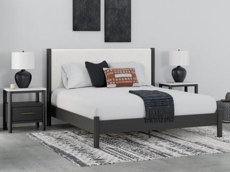 Cadmori King Upholstered Panel Bed frontal view with black finish and white upholstery