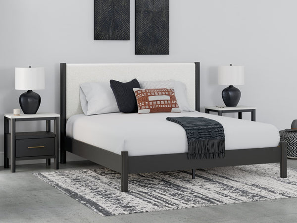 Cadmori King Upholstered Panel Bed frontal view with black finish and white upholstery