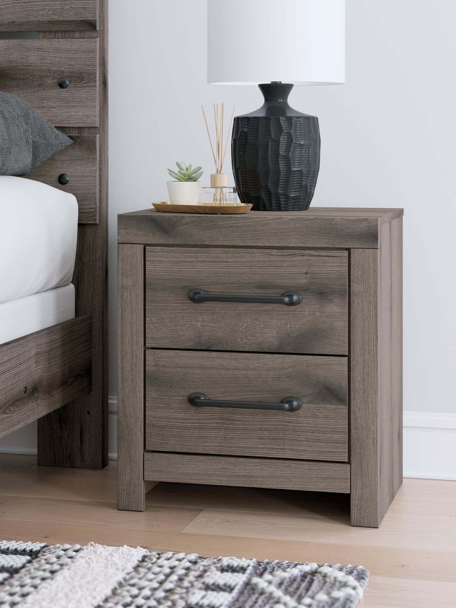 Graystorm brown gray nightstand front view showing drawers