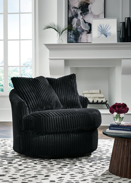 Gramwell Onyx Swivel Chair front view with plush corduroy upholstery and throw pillows