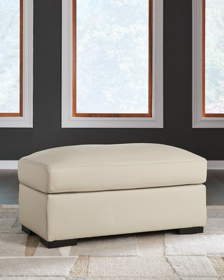Treasure Trove Almond Leather Match Ottoman angled side view