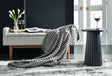 Alsonwell Gray Faux Fur Throw folded on sofa