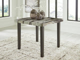 Jeshina dining table angled view showing faux marble top and tapered legs