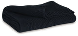 Gayelery black cotton throw folded on couch arm