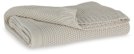 Gayelery Sand Cotton Throw folded on wooden surface