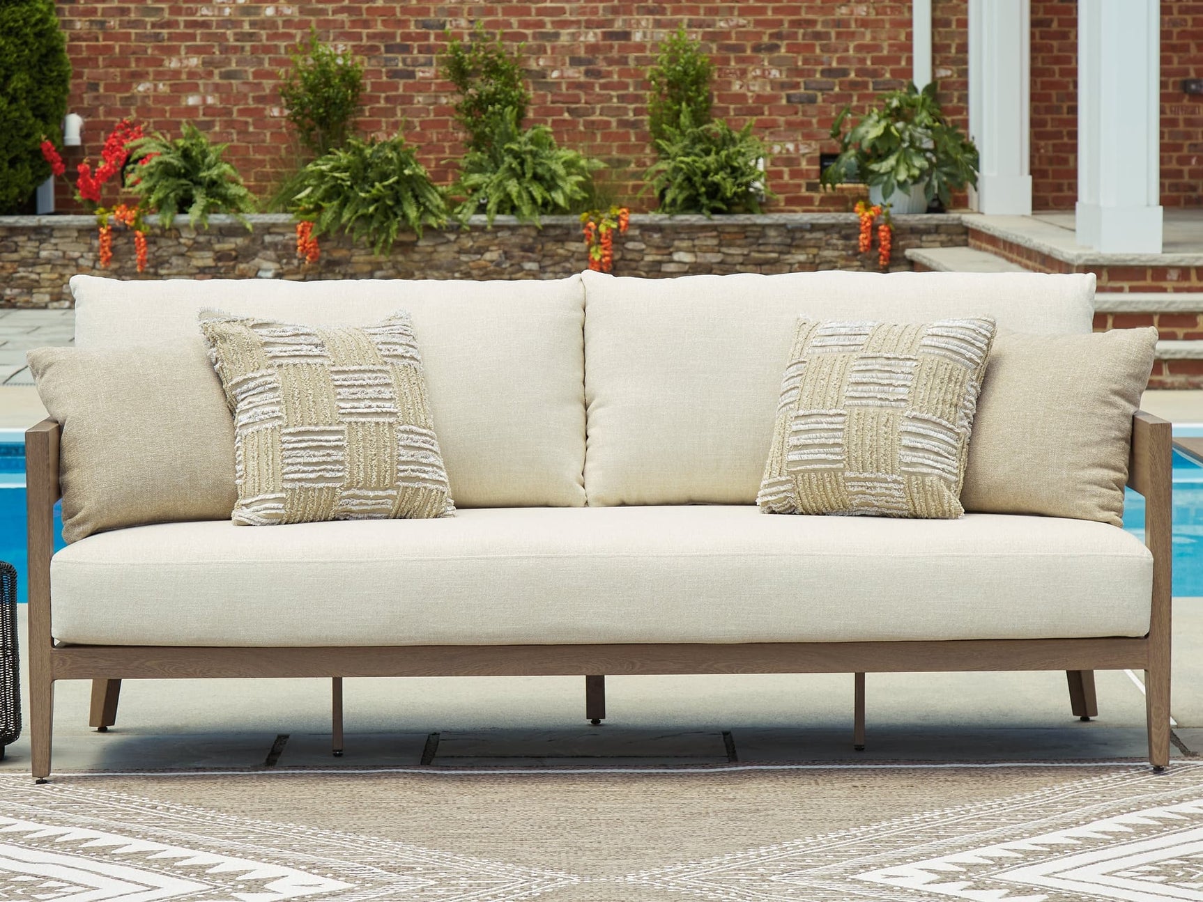 Serene Bay dark brown and white outdoor sofa with cushions front angle