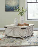 Carynhurst whitewash coffee table with dual-lid tabletop and hidden storage