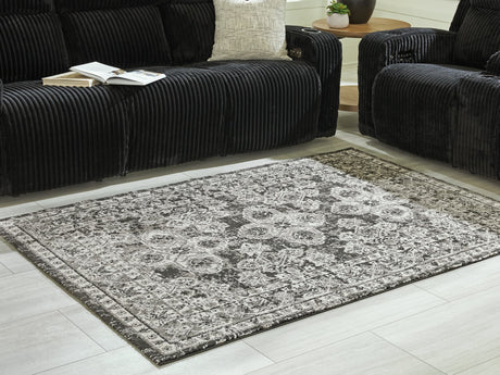 Glennisman Medium Rug angled view showing black gray ivory botanical pattern