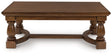 Sturlayne brown coffee table front angle showing detailed legs