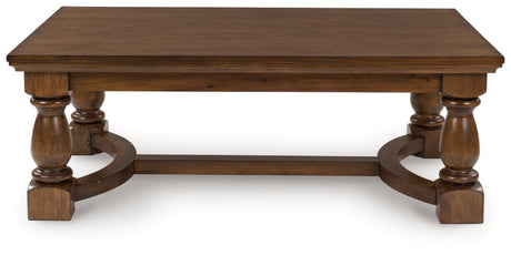 Sturlayne brown coffee table front angle showing detailed legs