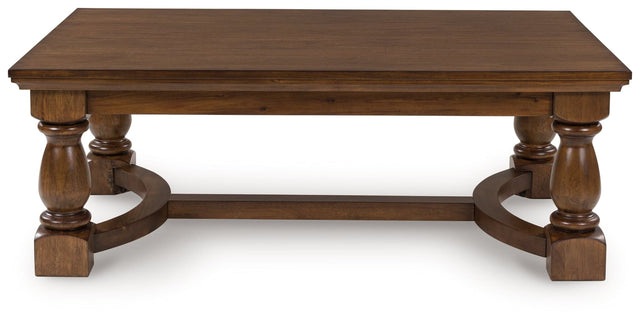Sturlayne brown coffee table front angle showing detailed legs
