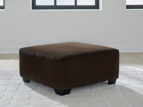 Kimlee oversized chocolate velvet accent ottoman angled view