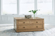 Sharlance light brown coffee table with dark bronze-tone drawer pulls, front view